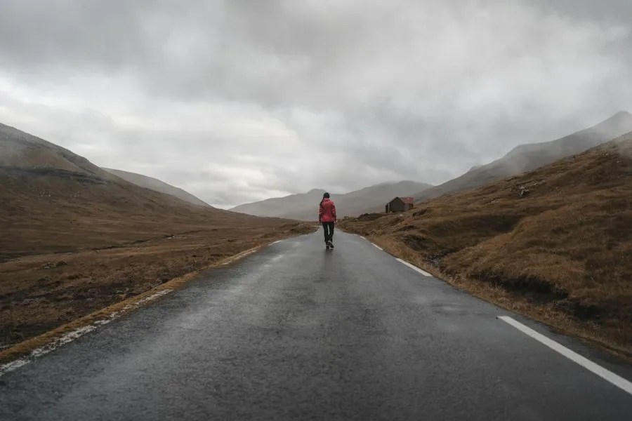 Person walking alone down a long road, representing recovery from addiction