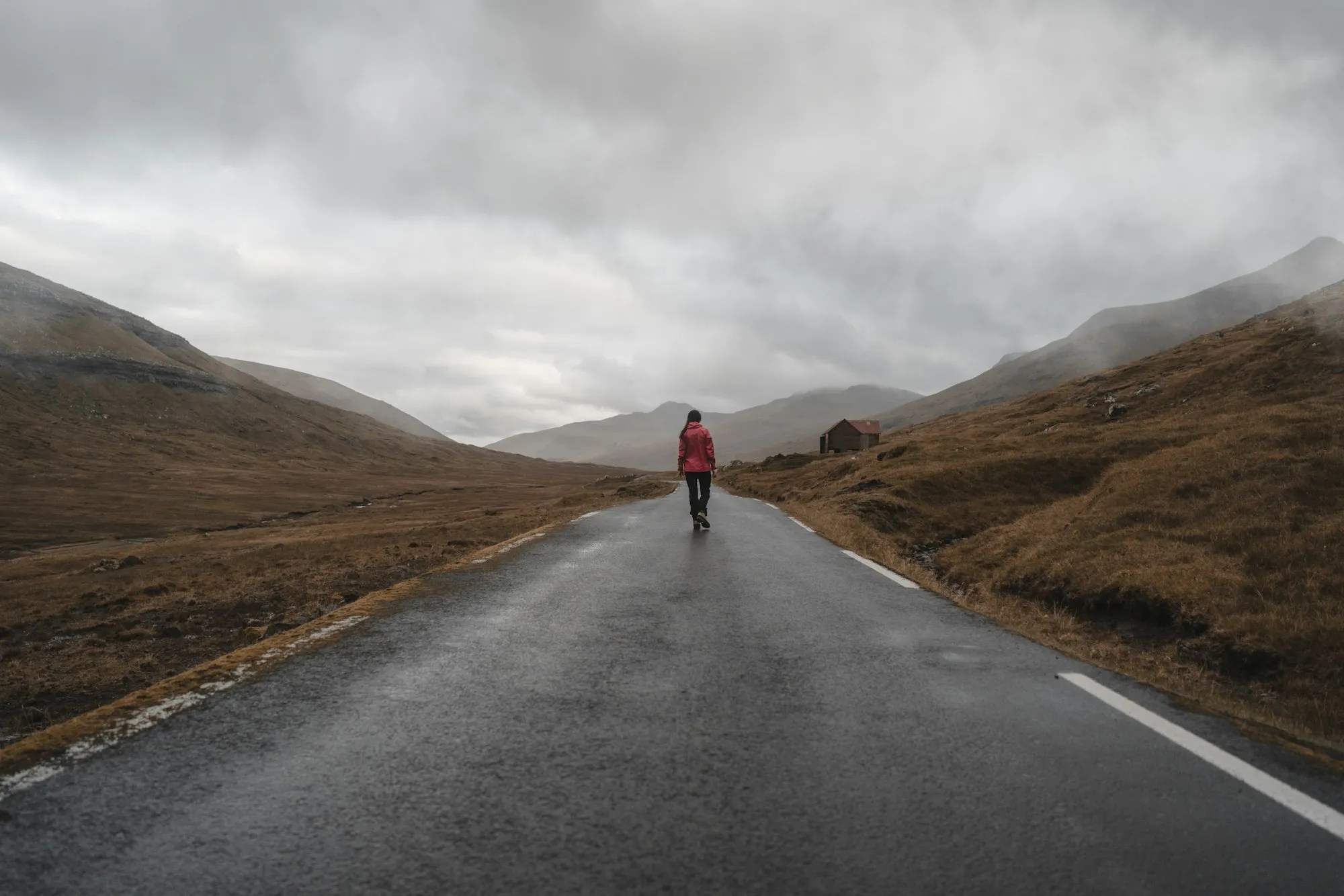 Person walking alone down a long road, representing recovery from addiction