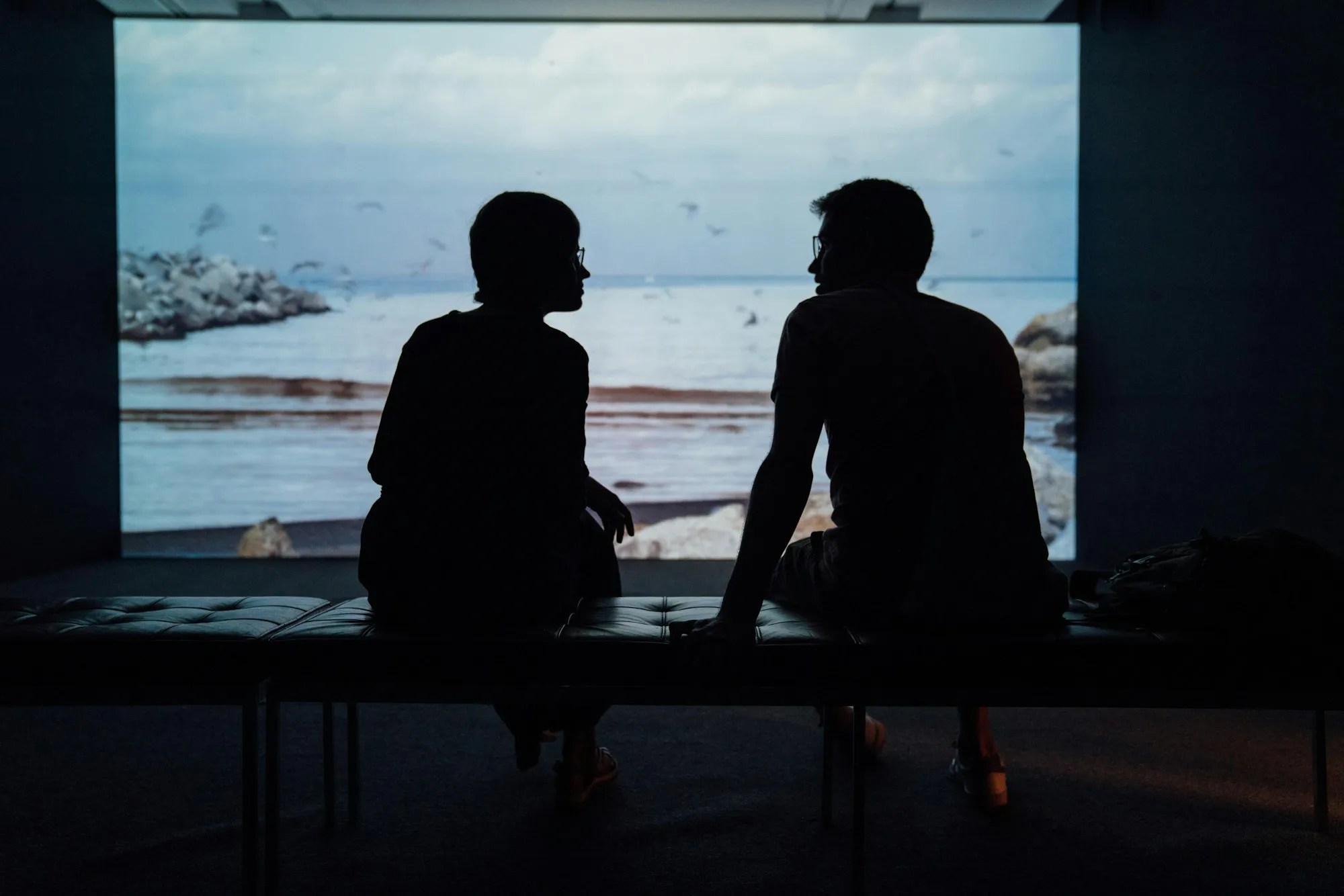 Two people silhouetted by a window, representing relationship difficulties