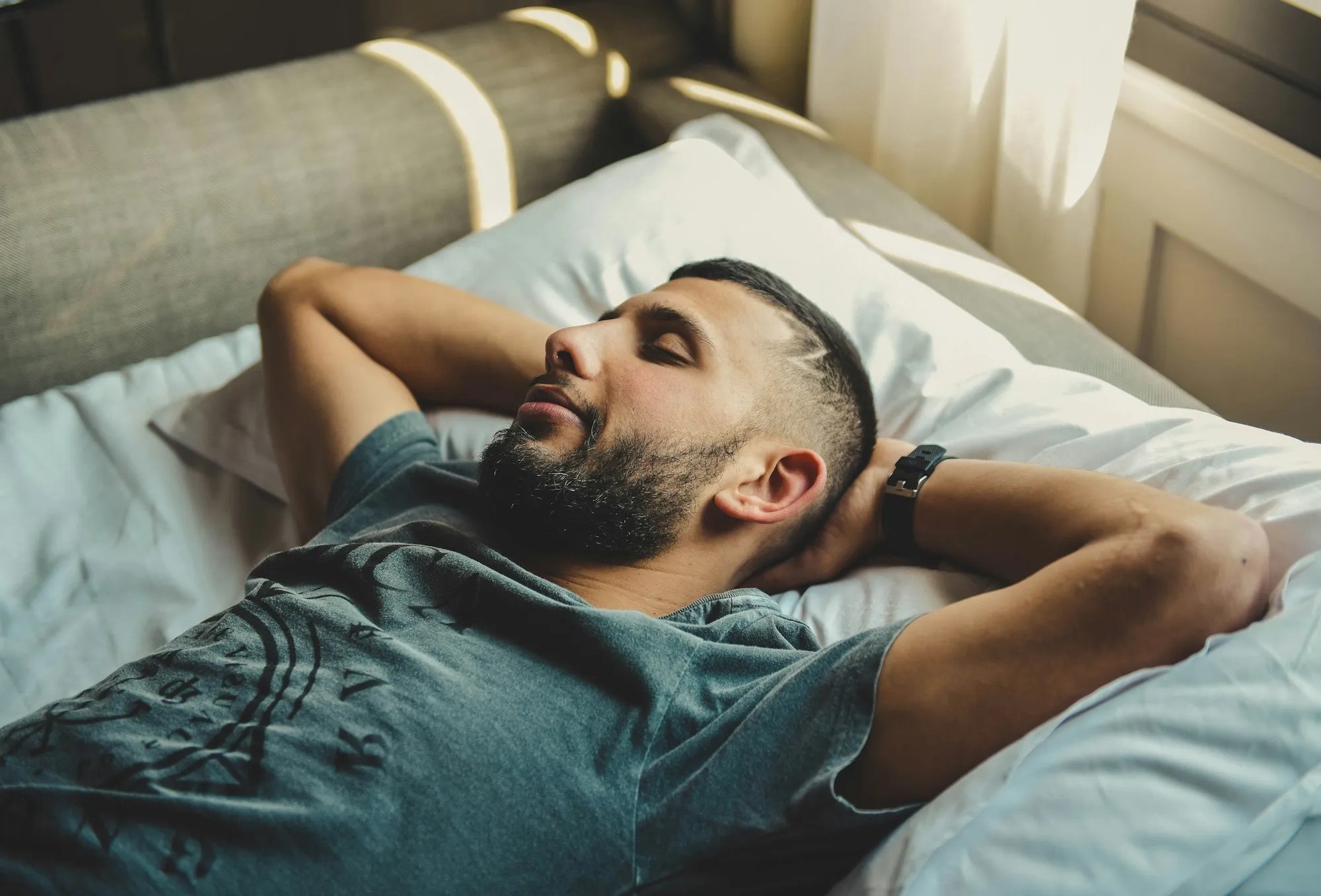 Man lying awake in bed, representing sleep difficulties and insomnia